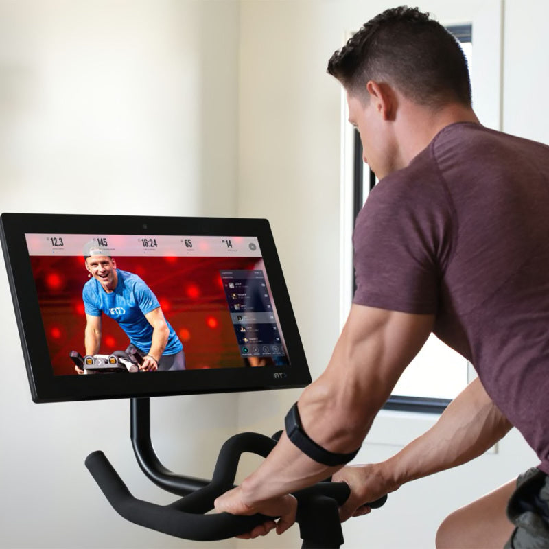 ProForm Studio Bike Pro 22 Lifestyle View with Man Watching Display